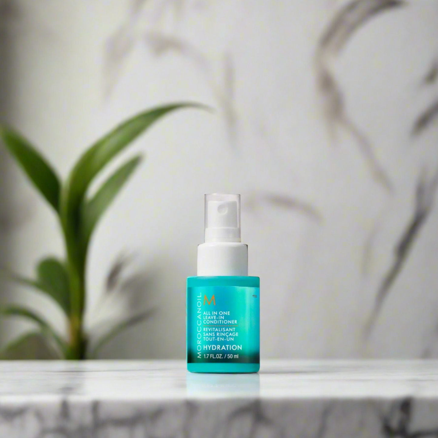 A 50ml bottle of Moroccanoil All-in-One Leave-In Conditioner, featuring a sleek, turquoise design with a white pump dispenser, designed to hydrate, detangle, and protect hair.