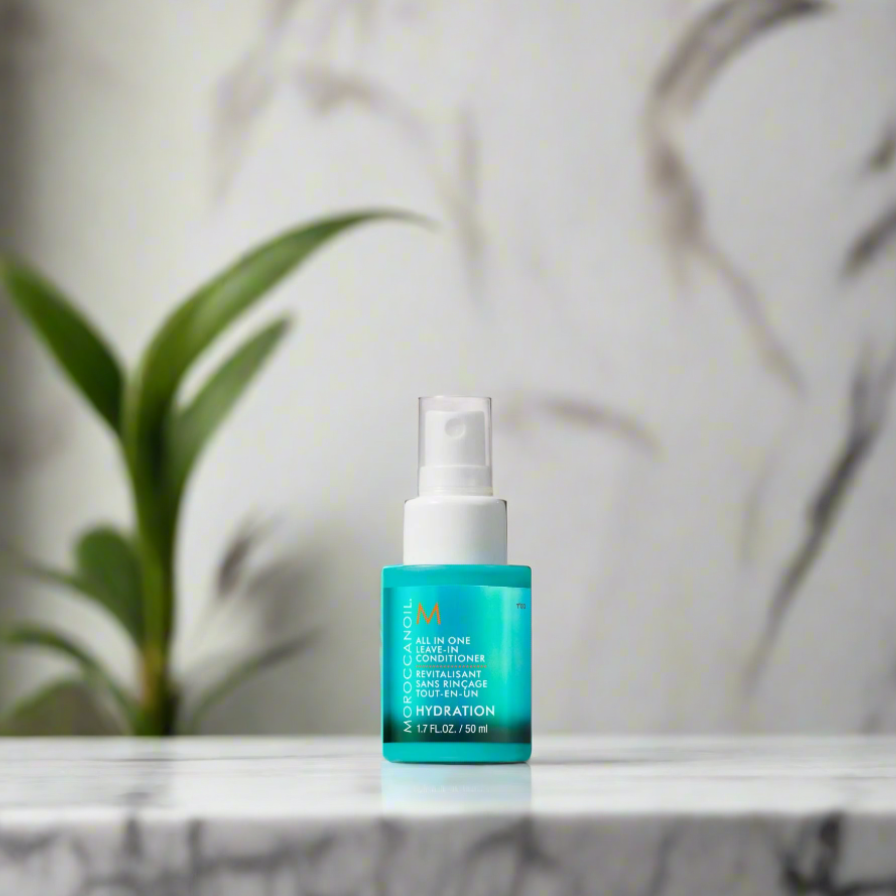 A 50ml bottle of Moroccanoil All-in-One Leave-In Conditioner, featuring a sleek, turquoise design with a white pump dispenser, designed to hydrate, detangle, and protect hair.
