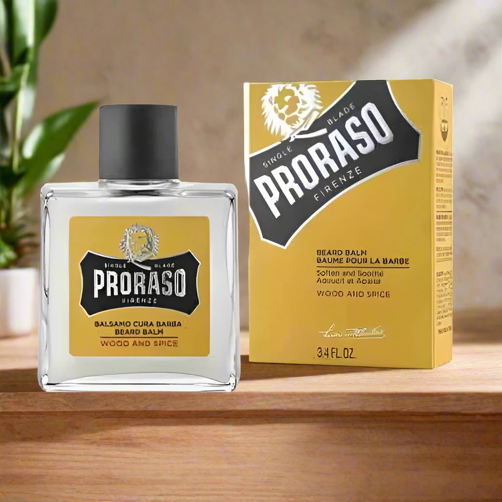 A 100ml jar of Proraso Beard Balm Wood and Spice. The packaging features a dark brown design with a silver label, highlighting the wood and spice scent. The jar is designed for convenient use and emphasizes the balm's conditioning and soothing properties.