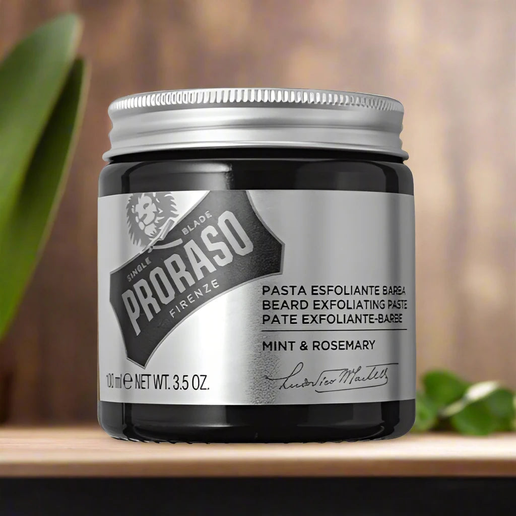 A 100ml tube of Proraso Beard Exfoliating Paste. The packaging features a white and green design with a clear label displaying the product name and its exfoliating properties. The tube is convenient for use in the shower or at the sink, emphasizing its cleansing and revitalizing benefits.
