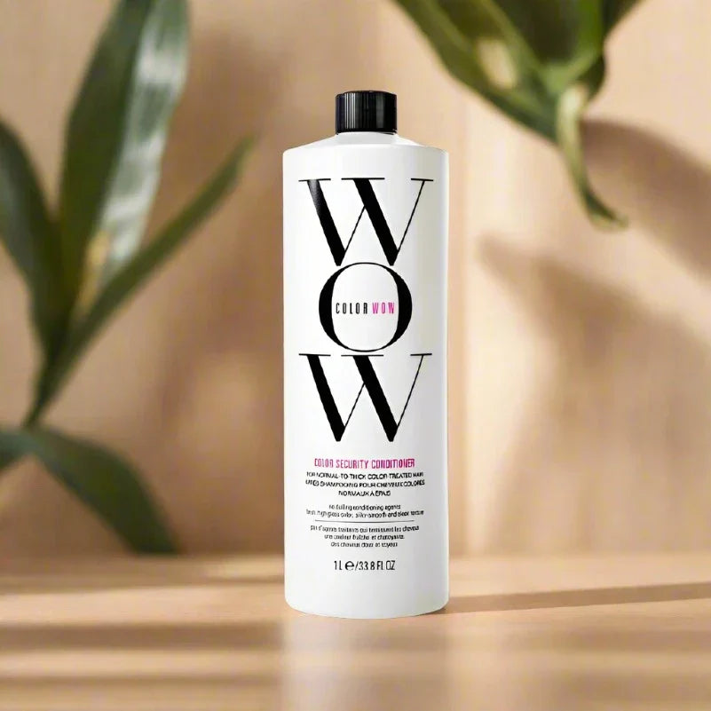 Front view of Color Wow Conditioner 1 Liter bottle featuring a white label with black and pink text and a black pump
