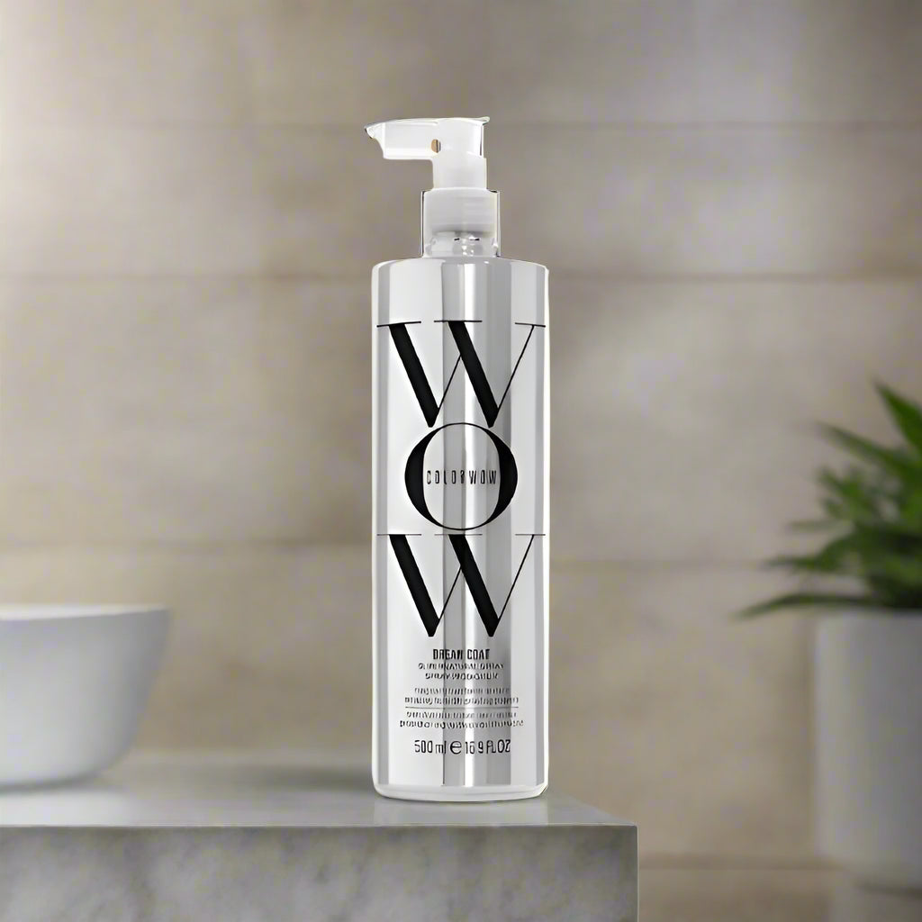 A 6.7 fl oz bottle of Color Wow Dream Coat Supernatural Spray with a blue label and black cap, designed for hair care.