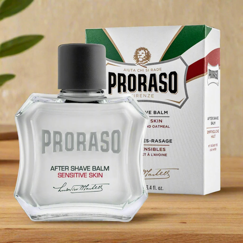 A 100ml bottle of Proraso After Shave Balm Sensitive. The packaging is white with a green cap and features a minimalist design with "Sensitive" clearly labeled. The bottle has a sleek, professional appearance with a simple label showcasing the product’s purpose for sensitive skin.
