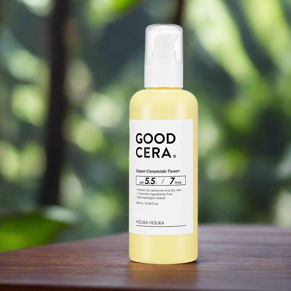 Holika Holika Good Cera toner bottle on a wooden surface with a blurred green background