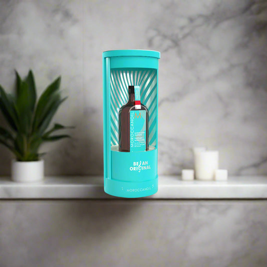 Teal cylindrical packaging with a bottle inside on a white background