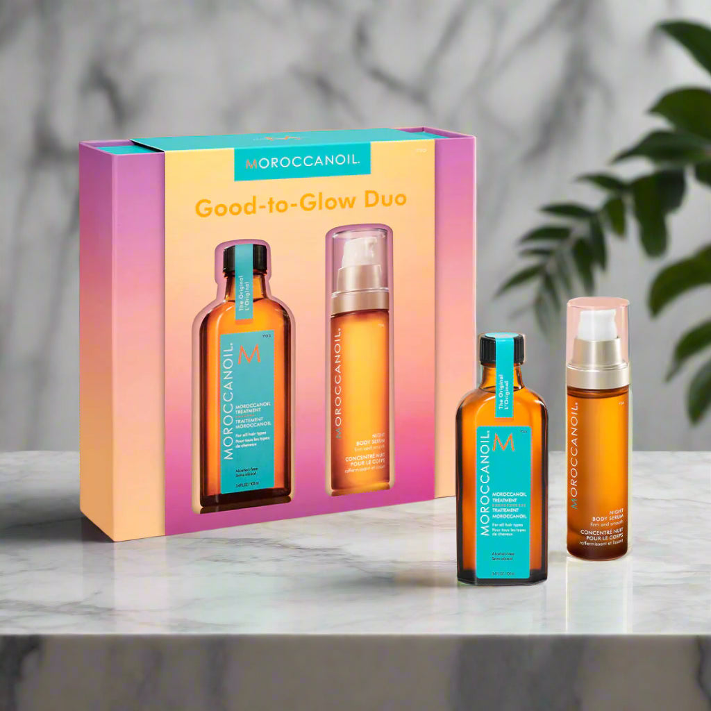 Moroccanoil Good-to-Glow Duo set with two bottles and a box on a gradient background