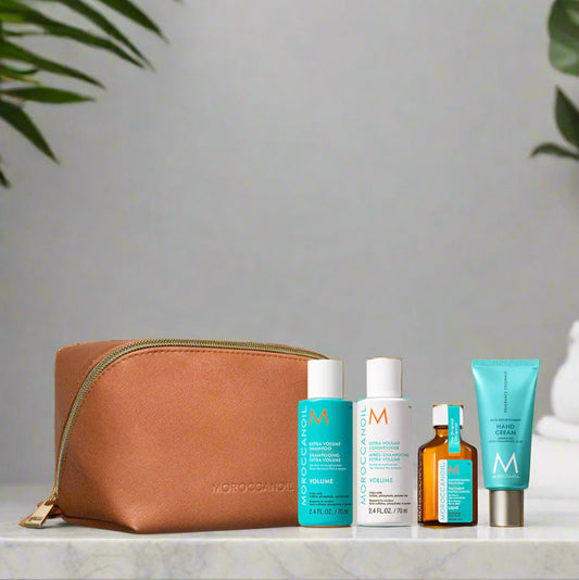 Set of skincare products with a brown pouch on a marble background