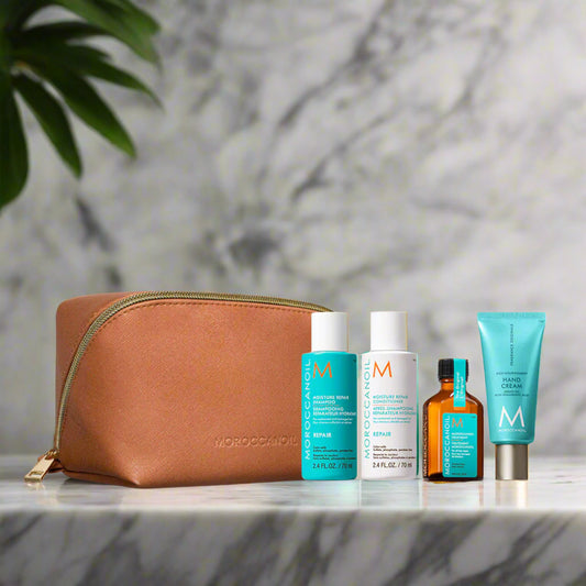 Lily and Co Essentials – Moroccanoil Travel 2025 Repair kit with travel‑size shampoo, conditioner, treatment oil, hand cream, and clear cosmetic pouch.