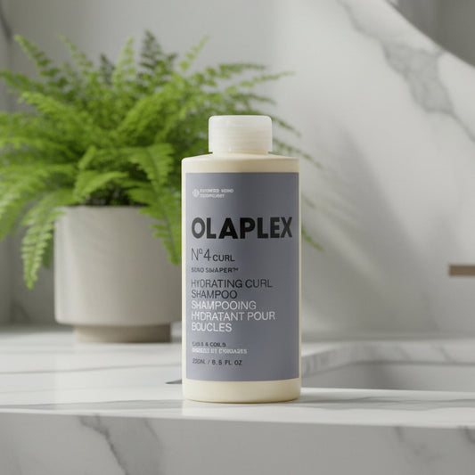 A 250ml bottle of Olaplex No. 4 Curl Hydrating Curl Shampoo on a plain white background.