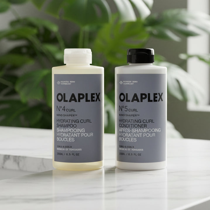 Two Olaplex bottles, one for shampoo and one for conditioner, on a white background.