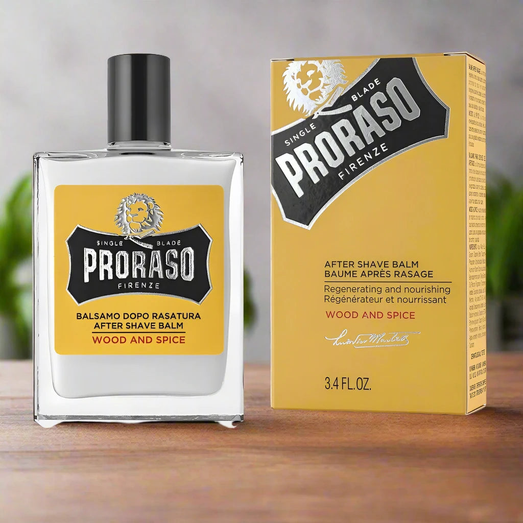 A 100ml bottle of Proraso After Shave Balm Wood and Spice. The packaging features a yellow and silver color scheme with a clear label displaying the product name and scent.