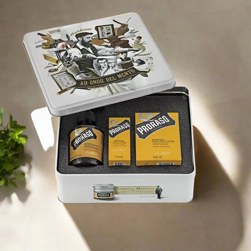A Proraso Beard Kit Wood and Spice, featuring three items: a beard wash, beard balm, and beard oil. The packaging showcases a dark brown and silver design with clear labels, highlighting the warm, woody, and spicy fragrance. The kit is neatly presented, emphasizing its complete beard care regimen.